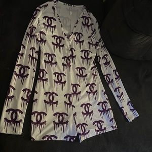 A medium. White with purple design. Romper. Originally bought online.